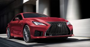 A red 2020 Lexus RC F flying down a city freeway.