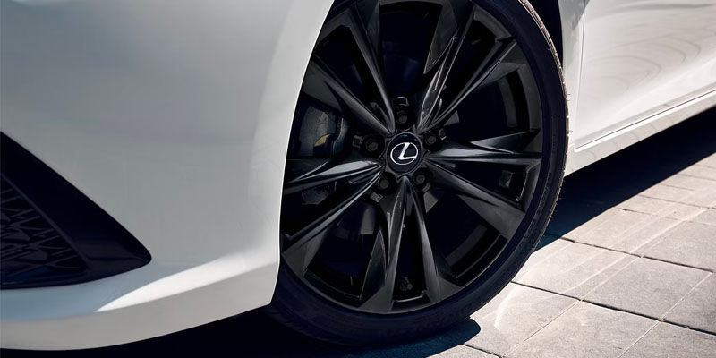 Front driver side wheel and tire of an all-new white Lexus ES. - Lexus of Huntsville, AL