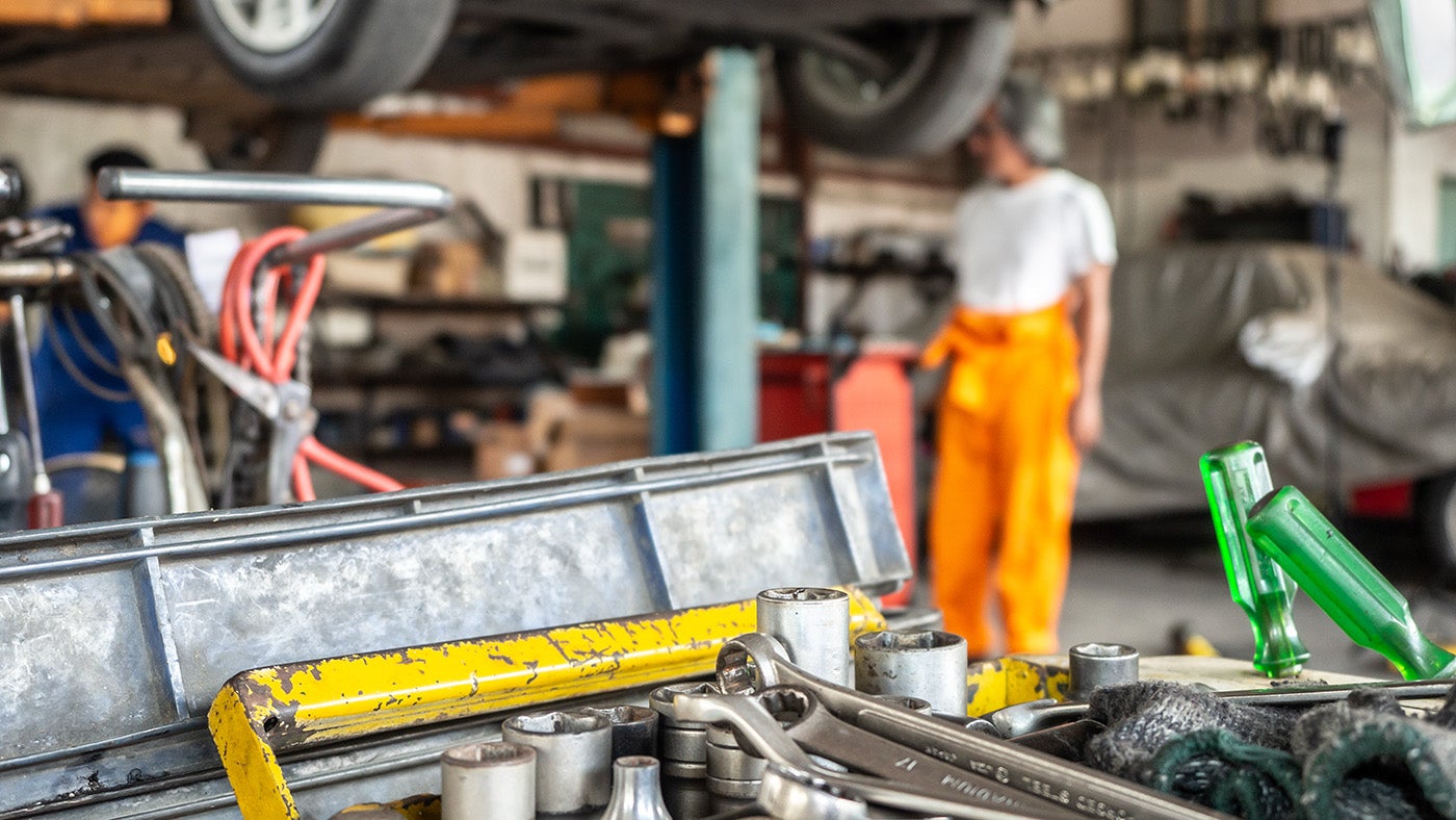 Mechanics Standing around in a Repair Shop