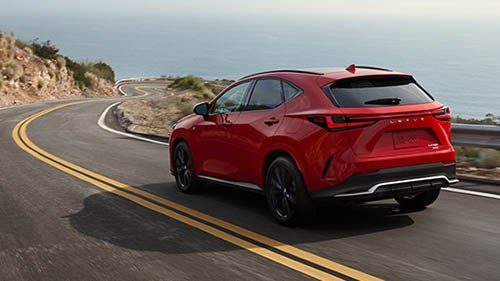 Red Lexus SUV Driving Down Road
